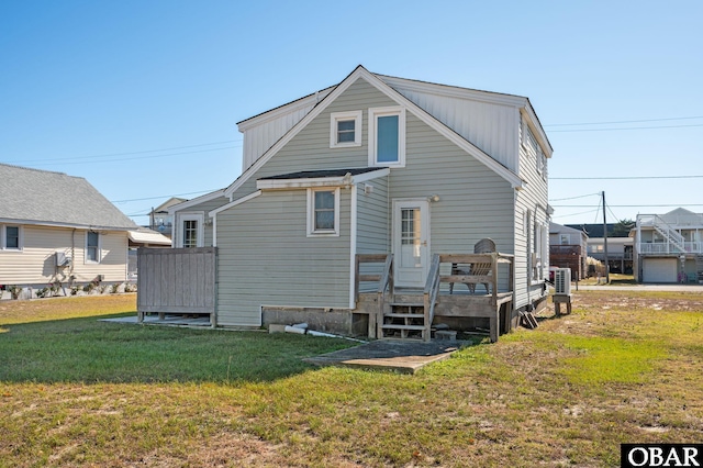 rear view of property with a lawn