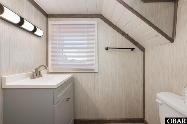 bathroom featuring toilet, wood ceiling, and vanity