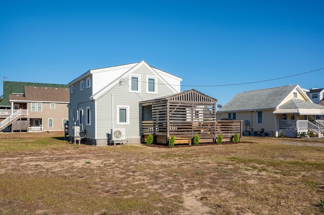 rear view of property with a lawn