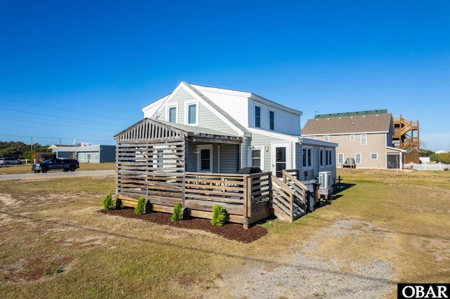 view of front of home with a front yard and a deck