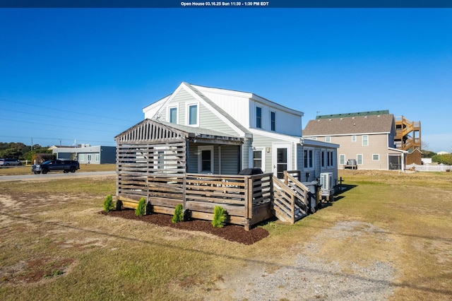 view of front of house featuring a wooden deck and a front lawn