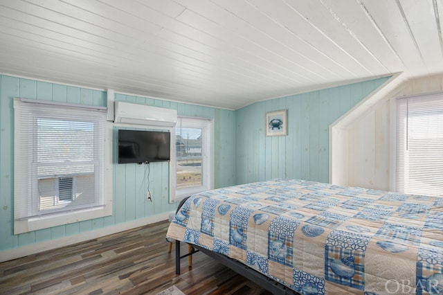 bedroom with a wall unit AC, wood ceiling, and dark wood-style flooring