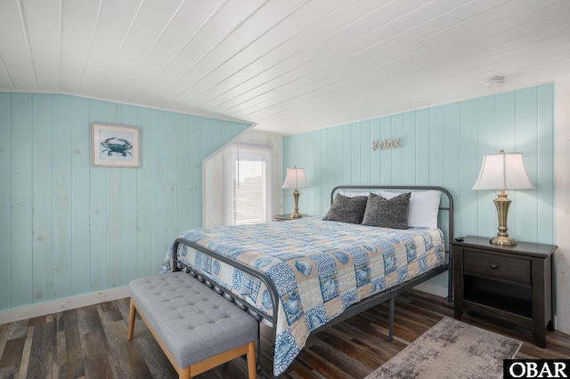 bedroom featuring wooden ceiling, baseboards, and wood finished floors