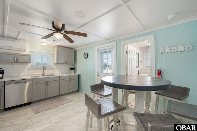 kitchen with ceiling fan, gray cabinetry, a sink, light countertops, and stainless steel dishwasher