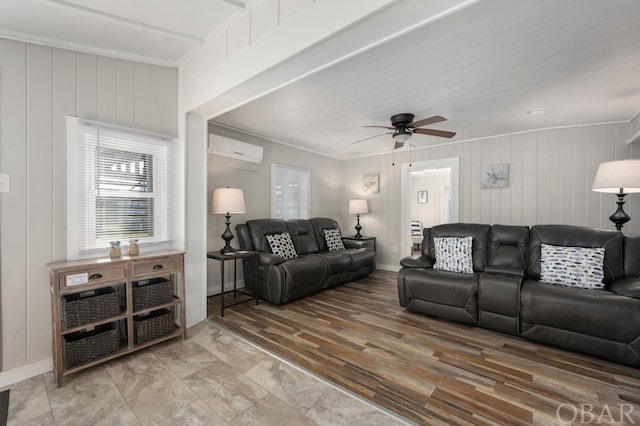 living room with ceiling fan, wood finished floors, a wealth of natural light, and a wall mounted air conditioner