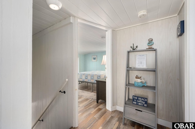 hallway featuring wooden ceiling and wood finished floors