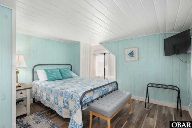 bedroom featuring baseboards and dark wood-type flooring