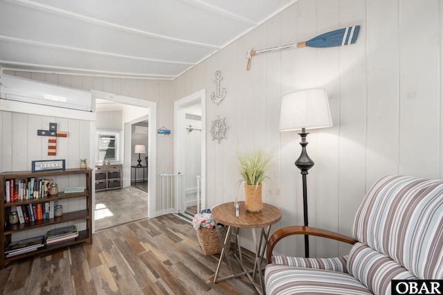 living area with dark wood-type flooring and lofted ceiling