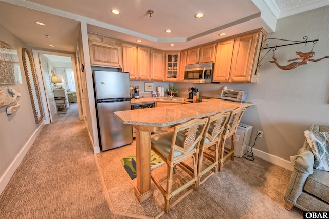 58822 Marina Way Unit 208, Hatteras, NC 27943 - kitchen with appliances with stainless steel finishes, light brown cabinets, recessed lighting, glass insert cabinets, and a peninsula