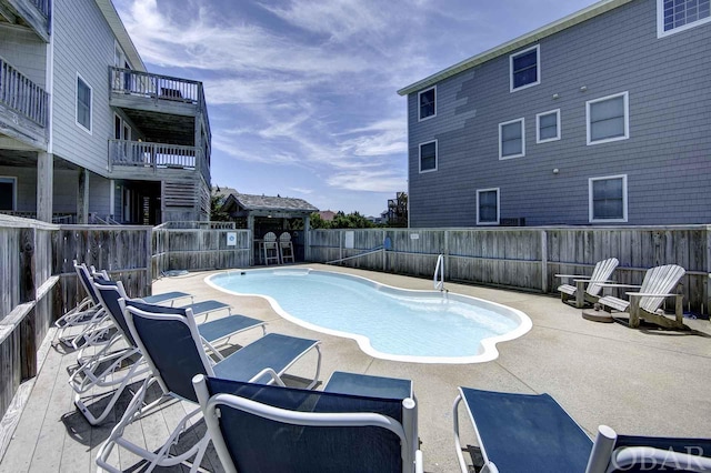 view of pool with a fenced in pool, a fenced backyard, and a patio