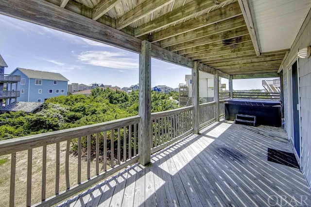 wooden deck with a hot tub