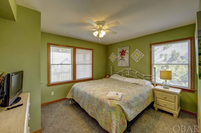 bedroom with ceiling fan, light colored carpet, and baseboards