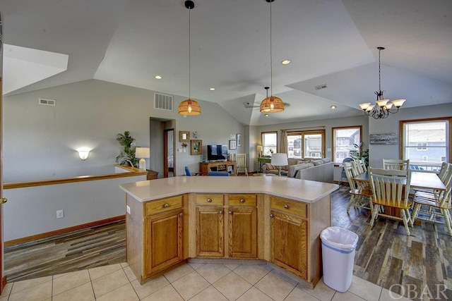 kitchen featuring light countertops, a center island, open floor plan, and visible vents