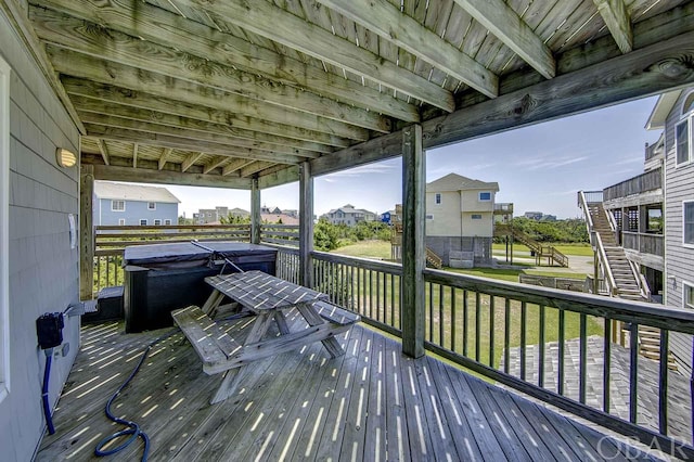 deck with stairway and a hot tub