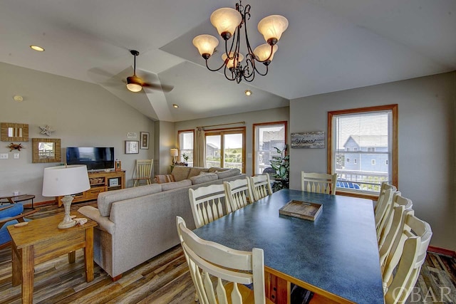 dining area with ceiling fan with notable chandelier, lofted ceiling, recessed lighting, and wood finished floors