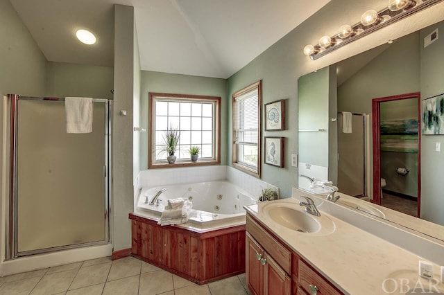 bathroom with a sink, tile patterned floors, double vanity, a tub with jets, and a stall shower