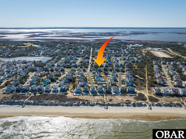 birds eye view of property featuring a water view and a view of the beach