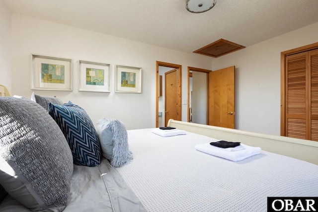 bedroom with a closet and a textured ceiling