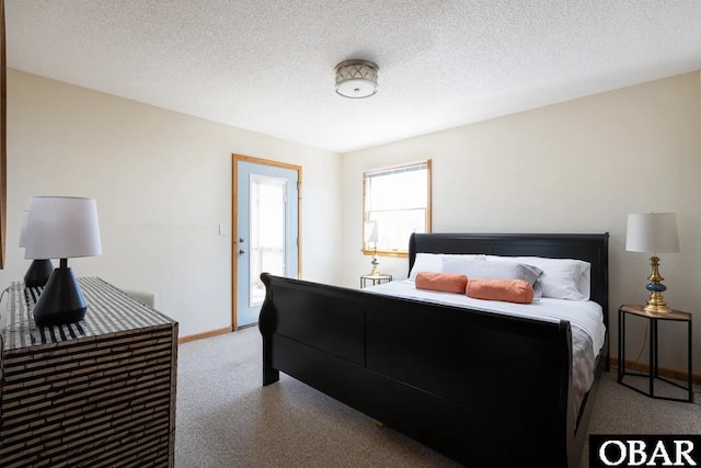 carpeted bedroom with baseboards and a textured ceiling