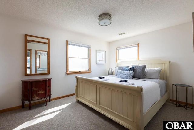 carpeted bedroom featuring visible vents, a textured ceiling, and baseboards