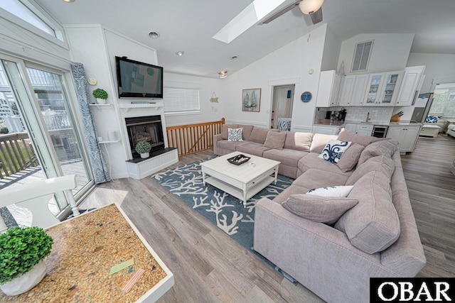 756 Mariner Dr Lot 2, Corolla, NC 27927 - living area featuring a skylight, plenty of natural light, light wood-type flooring, ceiling fan, and high vaulted ceiling