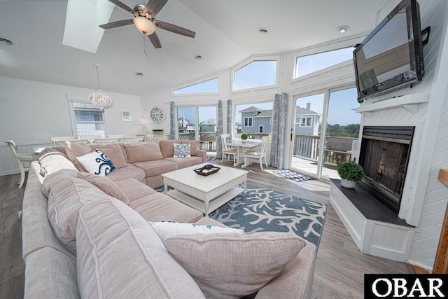 756 Mariner Dr Lot 2, Corolla, NC 27927 - living area featuring ceiling fan, wood finished floors, lofted ceiling, a fireplace with raised hearth, and healthy amount of natural light
