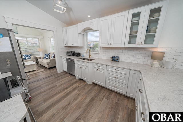 756 Mariner Dr Lot 2, Corolla, NC 27927 - kitchen featuring stainless steel appliances, vaulted ceiling, a sink, white cabinetry, and backsplash