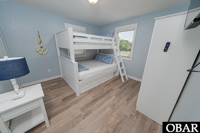 756 Mariner Dr Lot 2, Corolla, NC 27927 - bedroom with light wood-type flooring, baseboards, and a textured ceiling