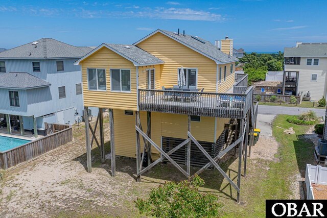 756 Mariner Dr Lot 2, Corolla, NC 27927 - back of property with a deck, fence, roof with shingles, and a chimney