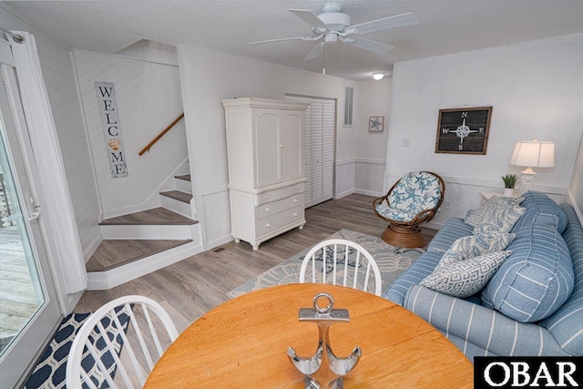 756 Mariner Dr Lot 2, Corolla, NC 27927 - dining room with wood finished floors, a ceiling fan, stairway, a wainscoted wall, and a textured ceiling