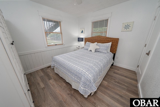 756 Mariner Dr Lot 2, Corolla, NC 27927 - bedroom with wood finished floors, wainscoting, and a ceiling fan