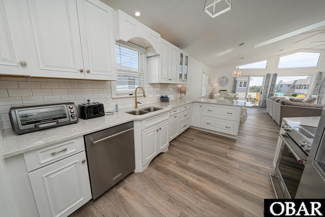 756 Mariner Dr Lot 2, Corolla, NC 27927 - kitchen with a sink, appliances with stainless steel finishes, a peninsula, white cabinets, and vaulted ceiling