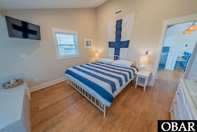 25259 Sea Isle Hills Dr Lot 7, Waves, NC 27982 - bedroom with lofted ceiling, wood finished floors, and baseboards