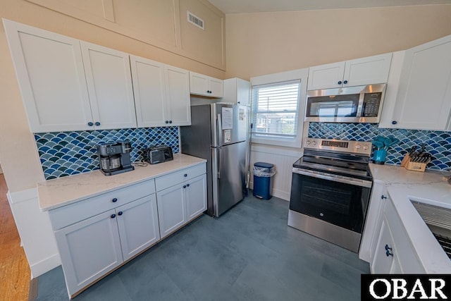 25259 Sea Isle Hills Dr Lot 7, Waves, NC 27982 - kitchen with stainless steel appliances, backsplash, white cabinetry, and light stone countertops