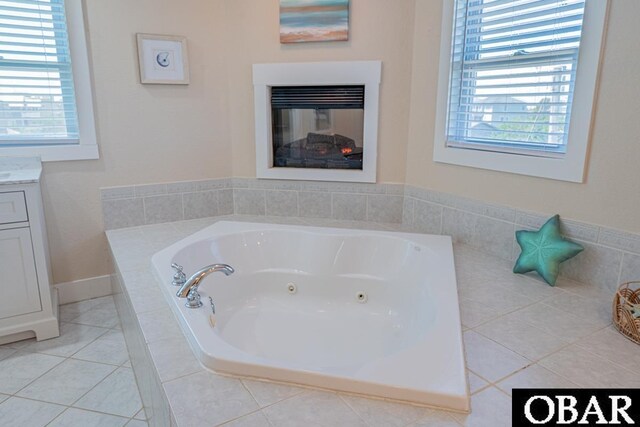 25259 Sea Isle Hills Dr Lot 7, Waves, NC 27982 - full bath featuring vanity, a tub with jets, a glass covered fireplace, and healthy amount of natural light