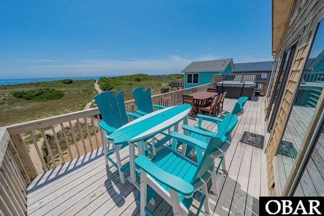 25259 Sea Isle Hills Dr Lot 7, Waves, NC 27982 - wooden terrace featuring outdoor dining area, a hot tub, and a water view