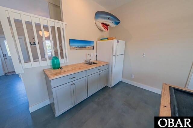 25259 Sea Isle Hills Dr Lot 7, Waves, NC 27982 - kitchen featuring freestanding refrigerator, a sink, baseboards, and butcher block countertops
