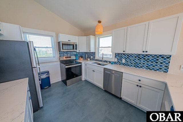25259 Sea Isle Hills Dr Lot 7, Waves, NC 27982 - kitchen featuring stainless steel appliances, a sink, lofted ceiling, decorative backsplash, and white cabinets