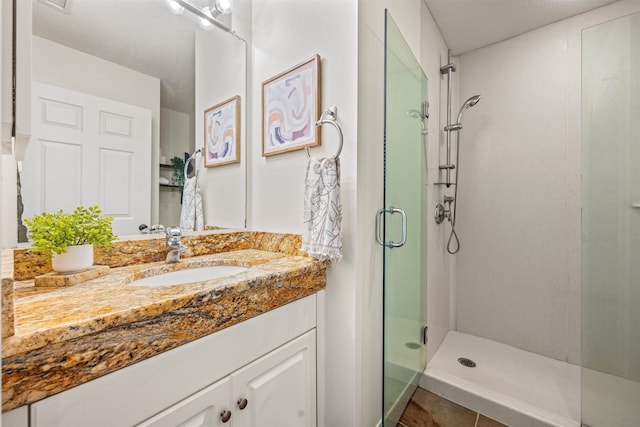 bathroom featuring a stall shower and vanity