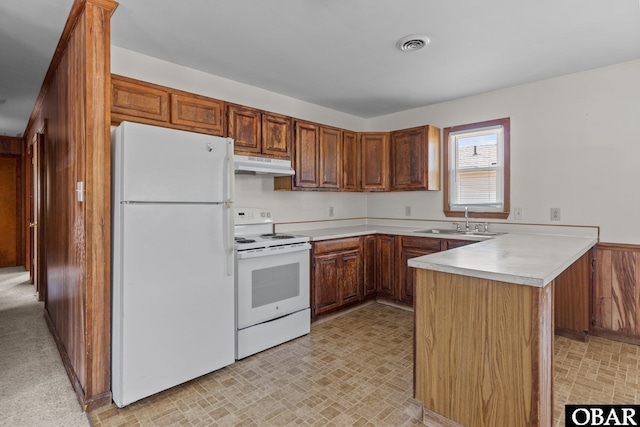 2018 Yorktown St Lot # 1365, Kill Devil Hills, NC 27948 - kitchen with white appliances, under cabinet range hood, a sink, light countertops, and a peninsula