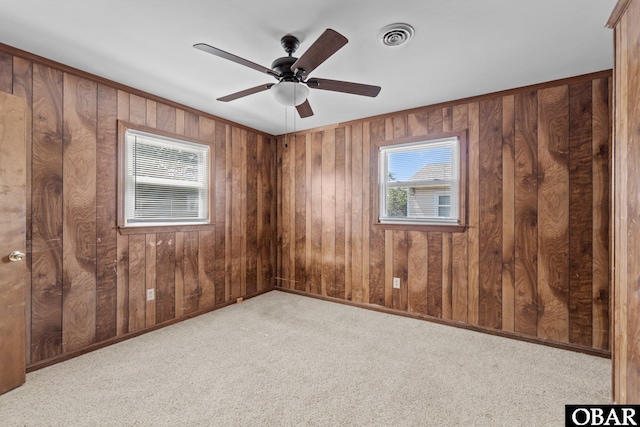2018 Yorktown St Lot # 1365, Kill Devil Hills, NC 27948 - empty room with plenty of natural light, carpet flooring, ceiling fan, and wooden walls