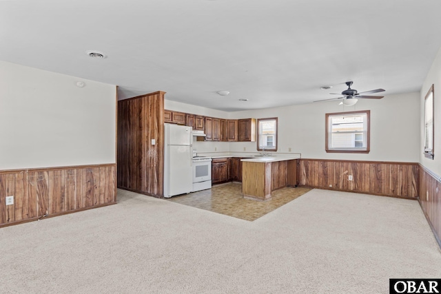 2018 Yorktown St Lot # 1365, Kill Devil Hills, NC 27948 - kitchen with white appliances, a peninsula, wainscoting, light countertops, and open floor plan