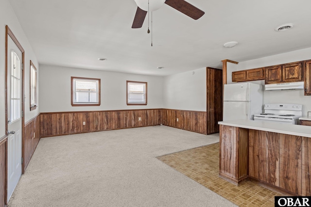 2018 Yorktown St Lot # 1365, Kill Devil Hills, NC 27948 - kitchen featuring white appliances, under cabinet range hood, a wainscoted wall, wooden walls, and a ceiling fan