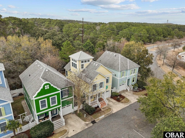 birds eye view of property with a view of trees