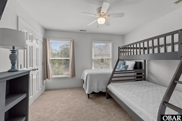 bedroom featuring multiple windows, carpet flooring, and visible vents