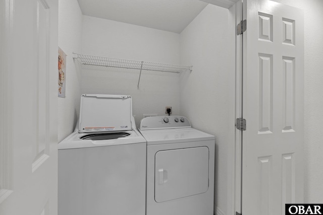 washroom featuring laundry area and washer and clothes dryer