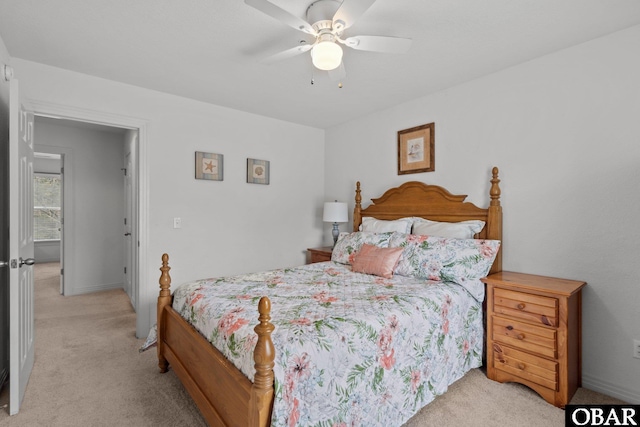 bedroom with light colored carpet and a ceiling fan