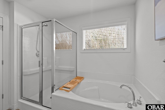 full bath featuring a garden tub and a stall shower