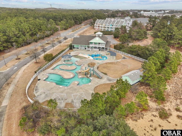 birds eye view of property featuring a view of trees