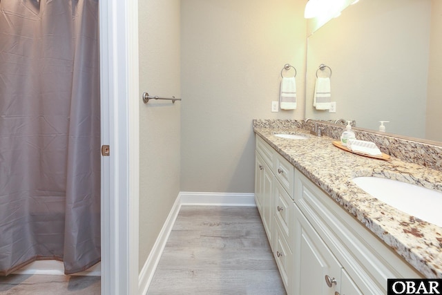 284 Old Swamp Rd, South Mills, NC 27976 - full bathroom with double vanity and wood finished floors